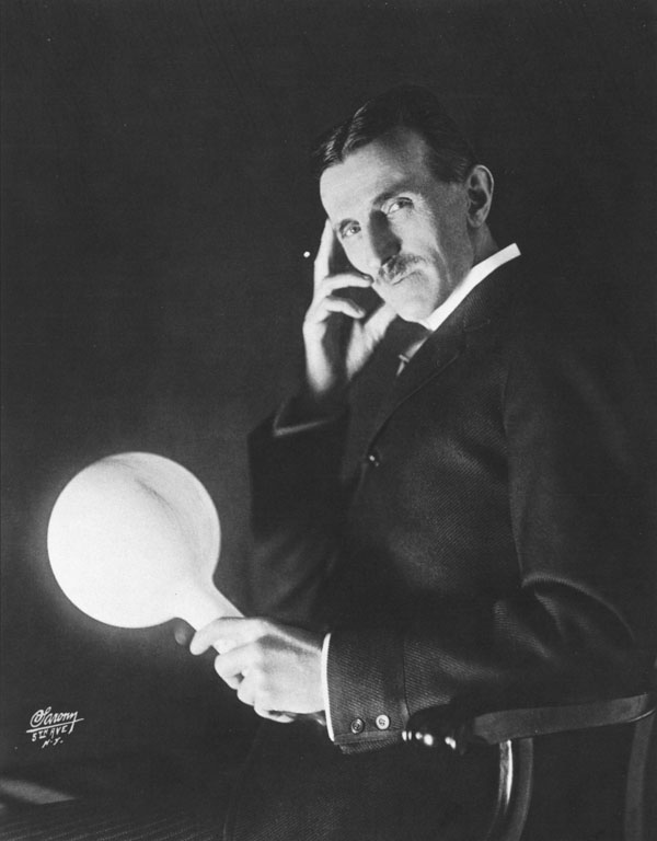 Nikola Tesla showing off one of his electric lights